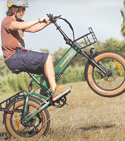 Person riding a green SAMEBIKE e-bike